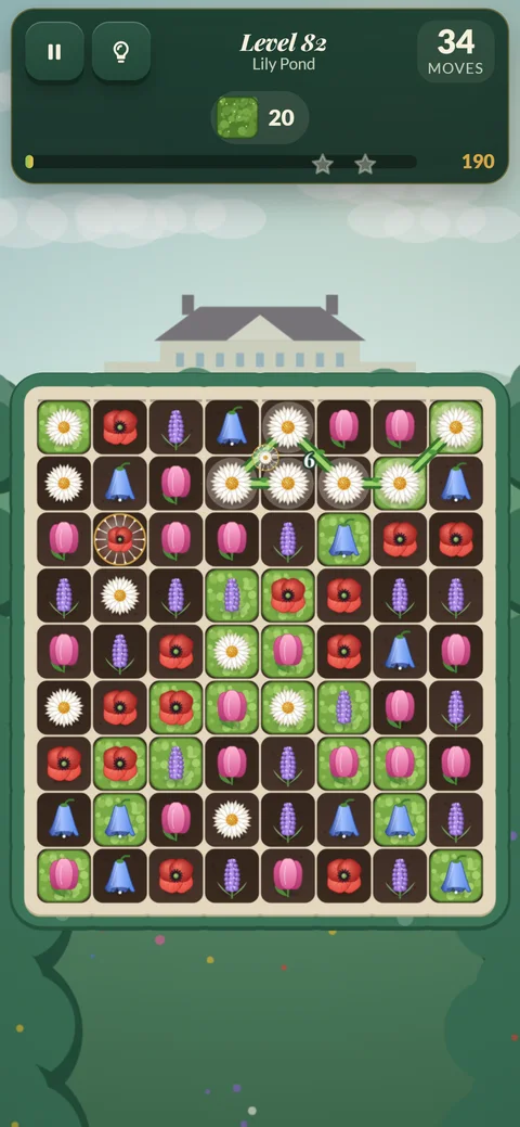 Garden Match Quest on a phone: level 82 at Lily Pond, a vine traced through six daisies on a board of flowers and green leaf tiles, with 34 moves left.
