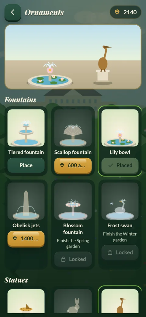 Garden Match Quest ornaments shop: fountains and statues to place in the garden, with a lily bowl fountain and heron statue placed.